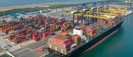 Container port operating with docked vessel.